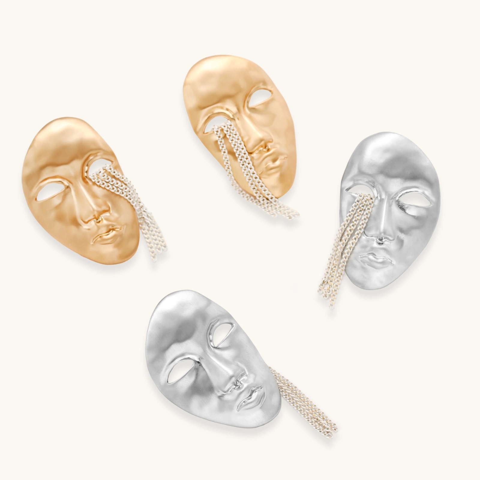 Sculptural face-shaped earrings with flowing chain tassels in polished eco-zinc alloy with sterling silver posts