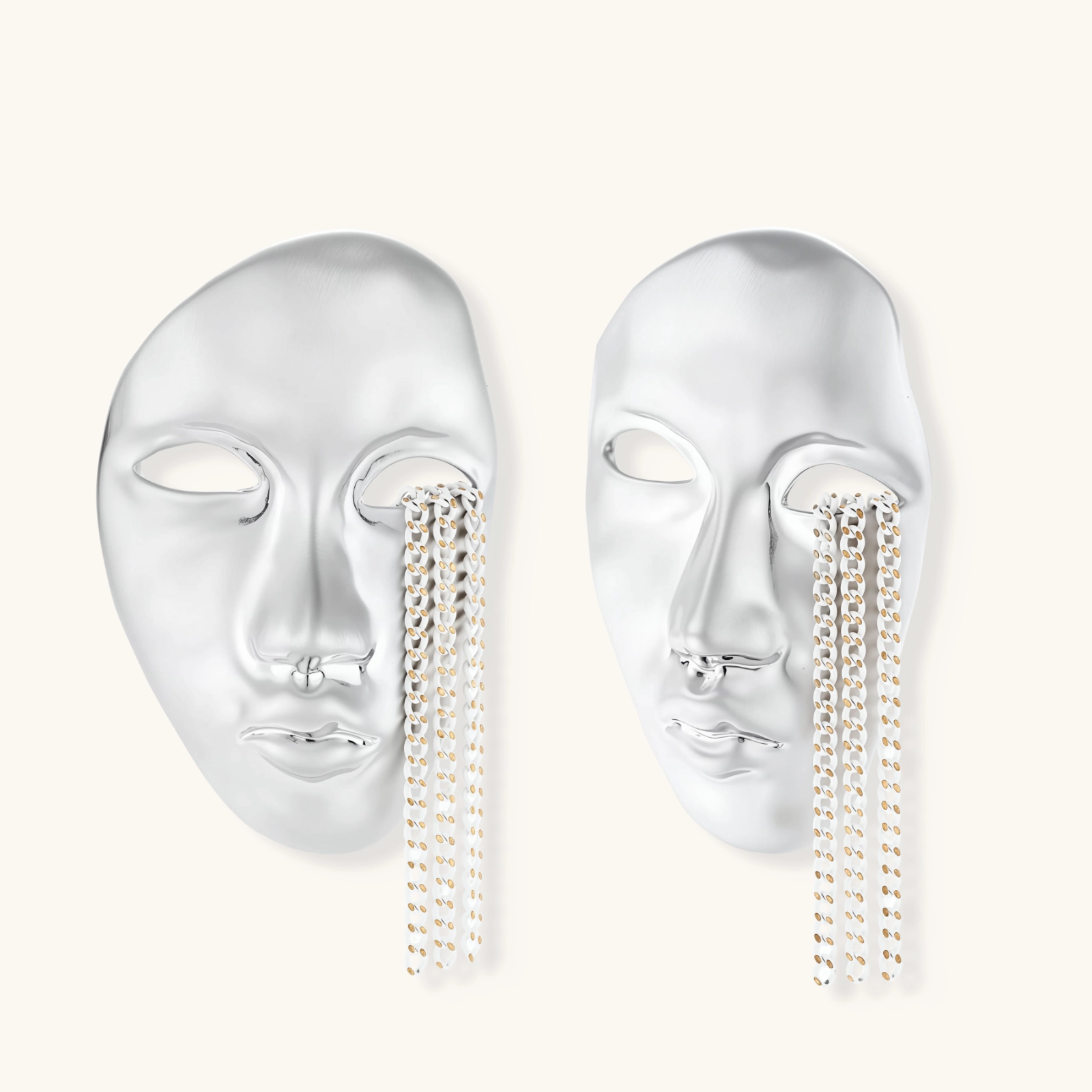 Sculptural face-shaped earrings with flowing chain tassels in polished eco-zinc alloy with sterling silver posts