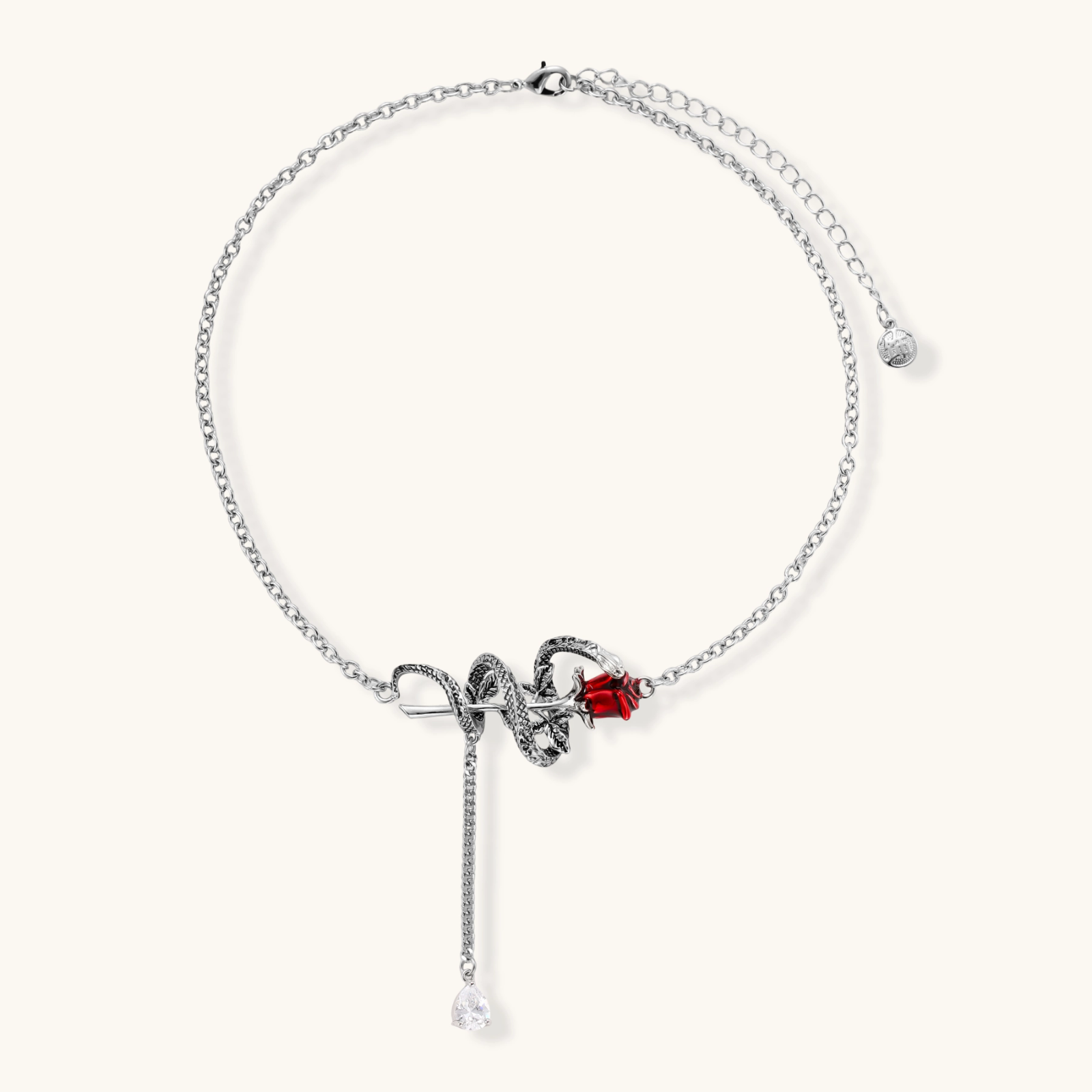 Detailed eco-brass serpent pendant necklace with red zirconia stone and crystal drop tassel on adjustable chain