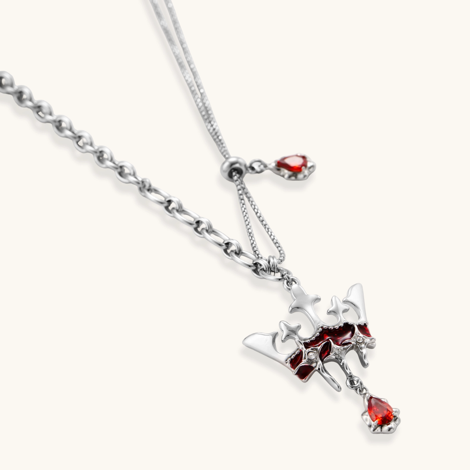 Eco-brass crown pendant necklace with red enamel details and dangling zirconia stone on chunky adjustable chain
