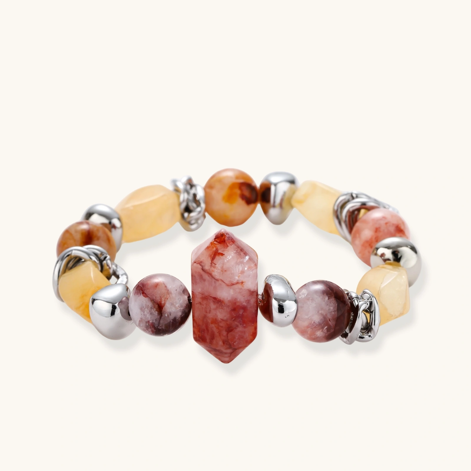 Stretch bracelet with amber citrine beads, red crystal stones and brass accents featuring a hexagonal centerpiece on white background.