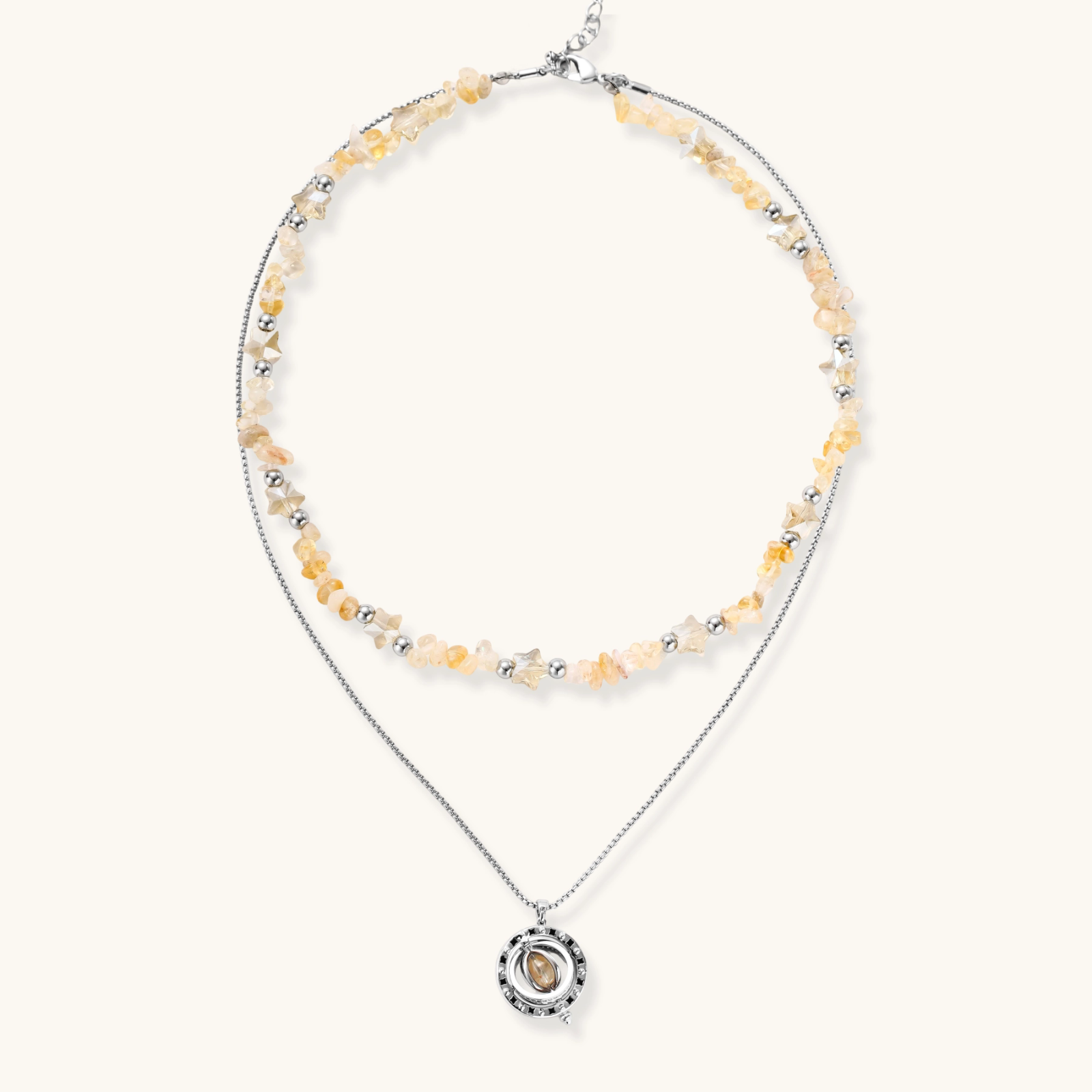 Two-layer necklace with natural stone chips and eco-brass beads, featuring a circular wrapped pendant on cream background.