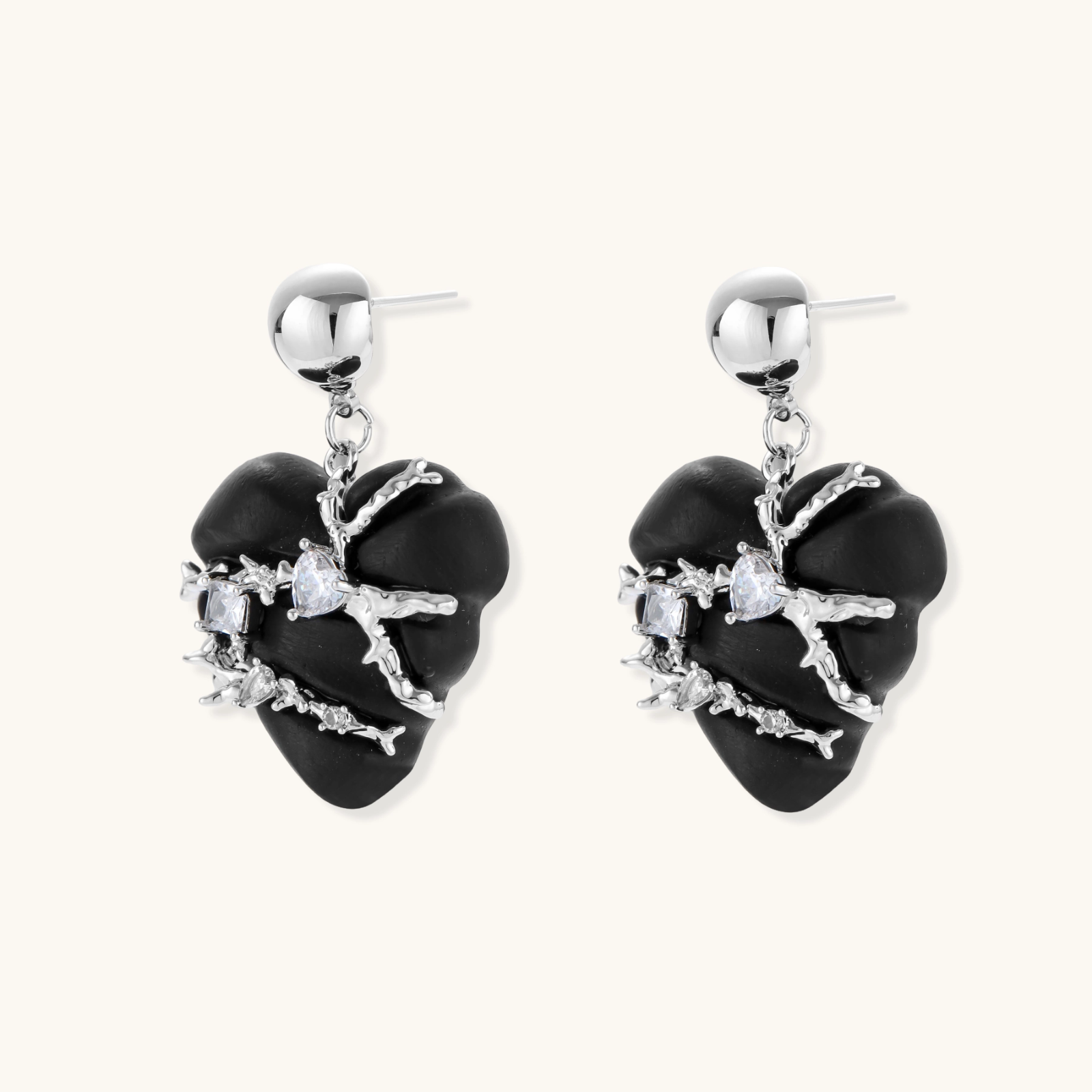 Heart-shaped wood earrings wrapped in silver wire with zirconia crystals, featuring ball stud posts on white background.