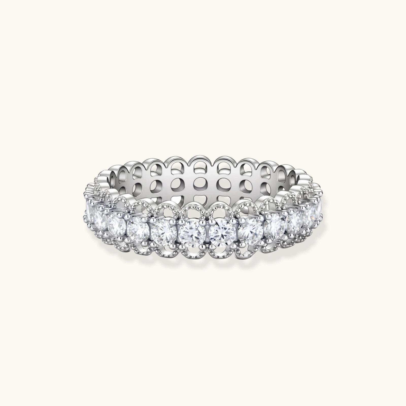 Sterling silver eternity ring with continuous row of brilliant moissanite stones in scalloped crown setting with milgrain detail