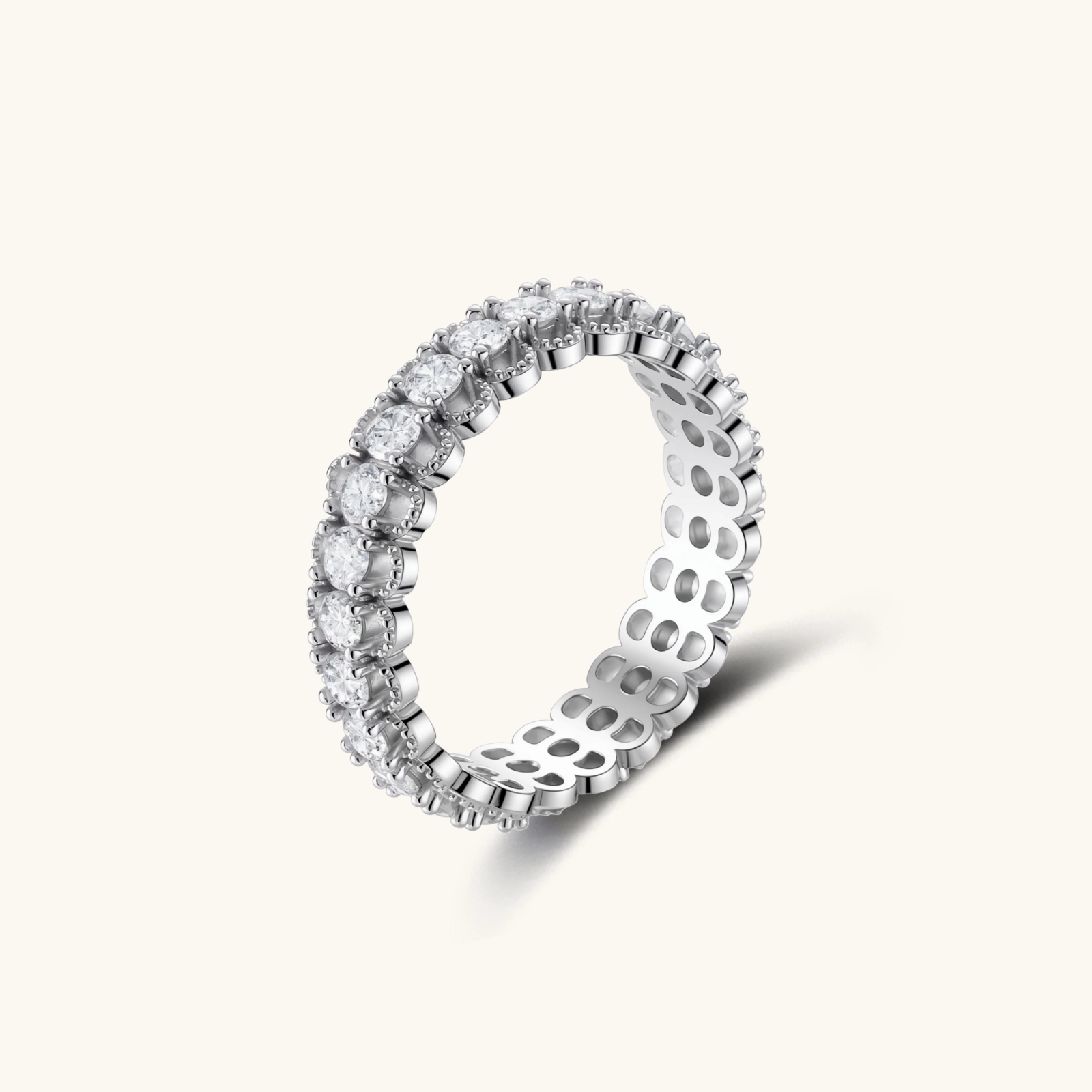 Sterling silver eternity ring with continuous row of brilliant moissanite stones in scalloped crown setting with milgrain detail