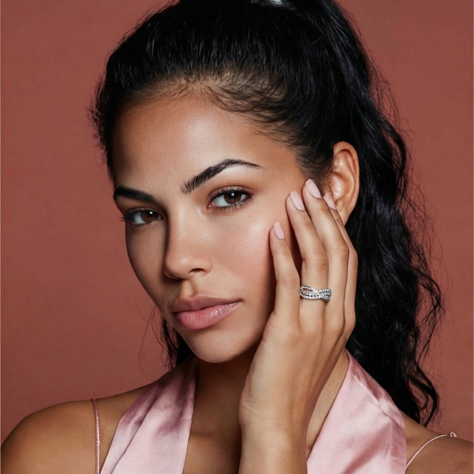 Sterling silver crossover ring with pavé-set moissanite stones creating an elegant infinity design on neutral background