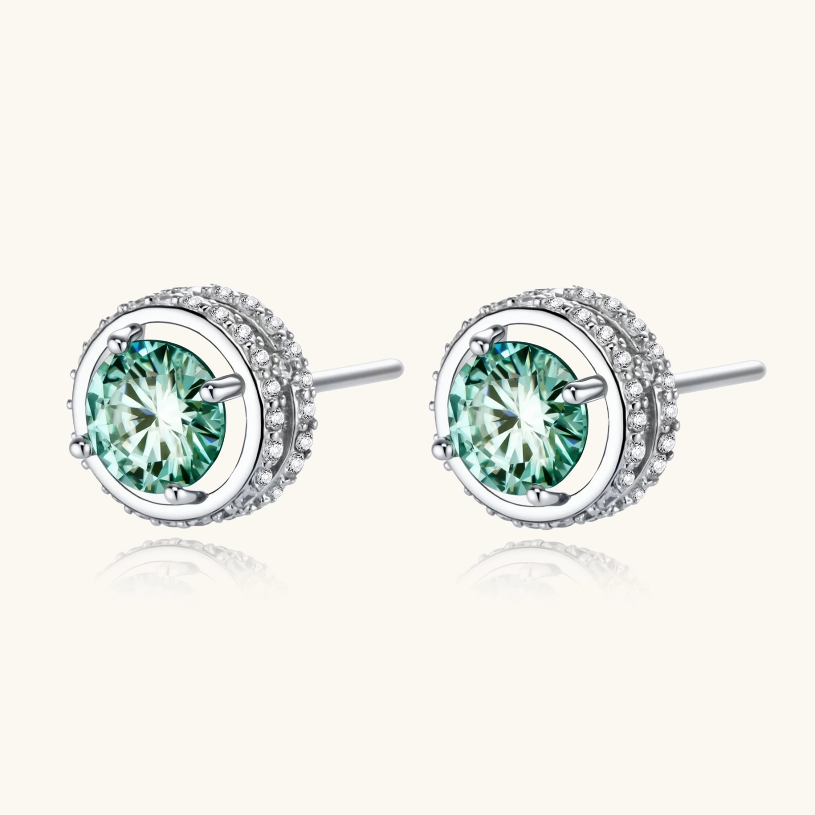Round green moissanite stud earrings in sterling silver halo settings with brilliant sparkle on white background.