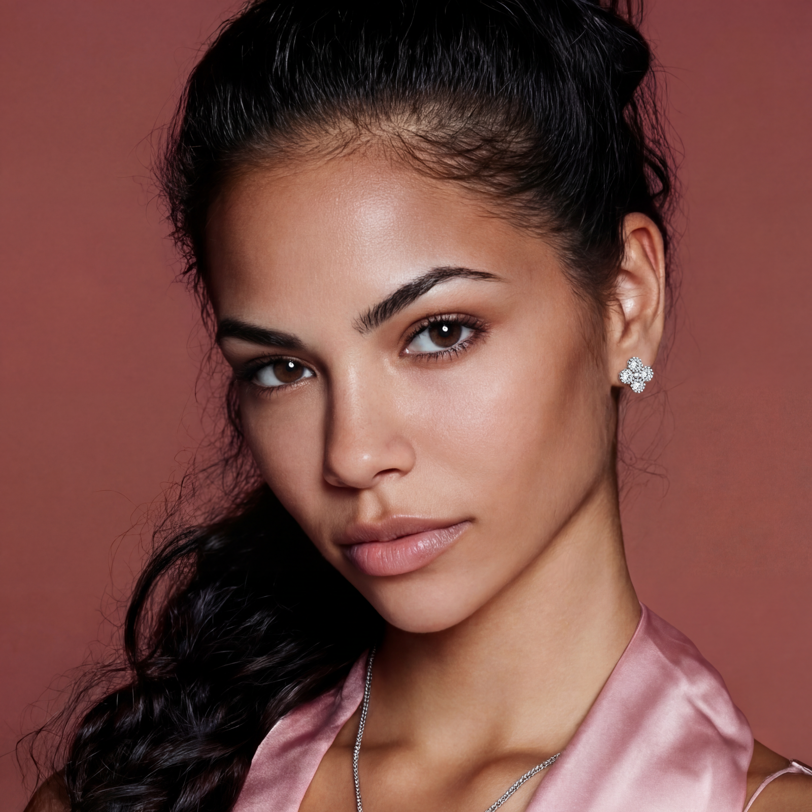 Dainty sterling silver quatrefoil stud earrings with four brilliant moissanite stones and center accent on white background.