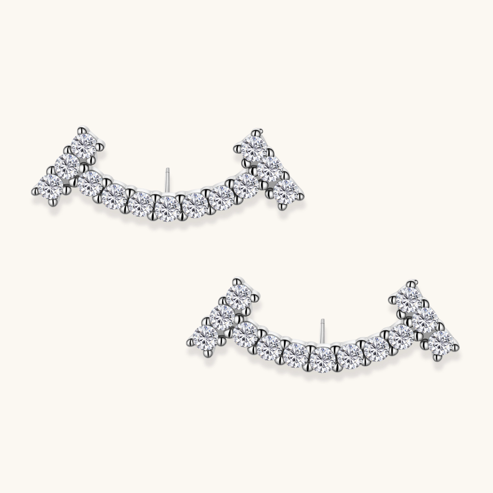 Curved sterling silver ear climbers with moissanite stones arranged in elegant arc shape on white background