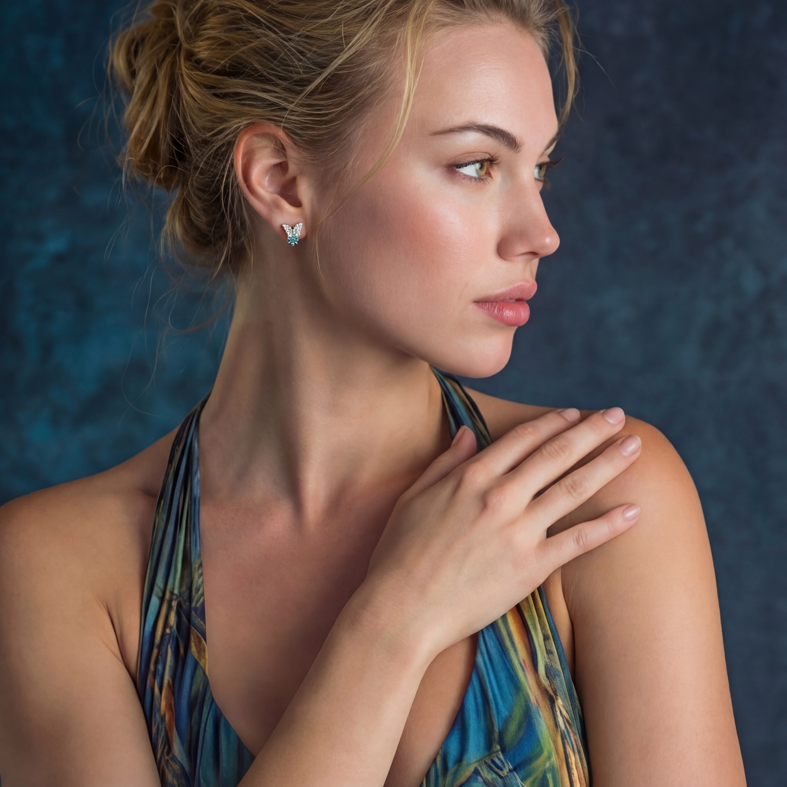 Sterling silver butterfly stud earrings with crystal wings and mint green center stones on cream background.