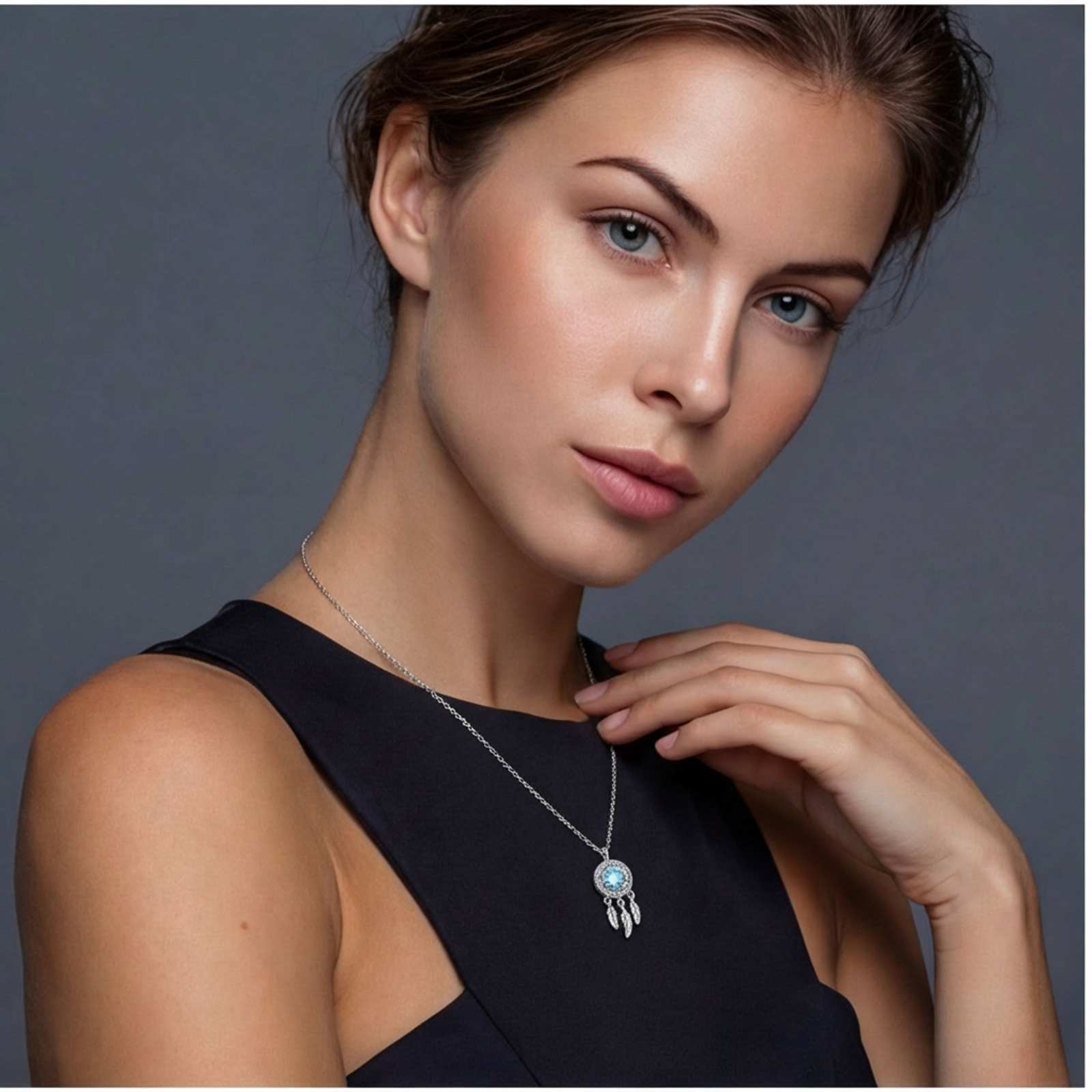 Sterling silver dreamcatcher pendant with blue moissanite center and three feather charms on adjustable chain.