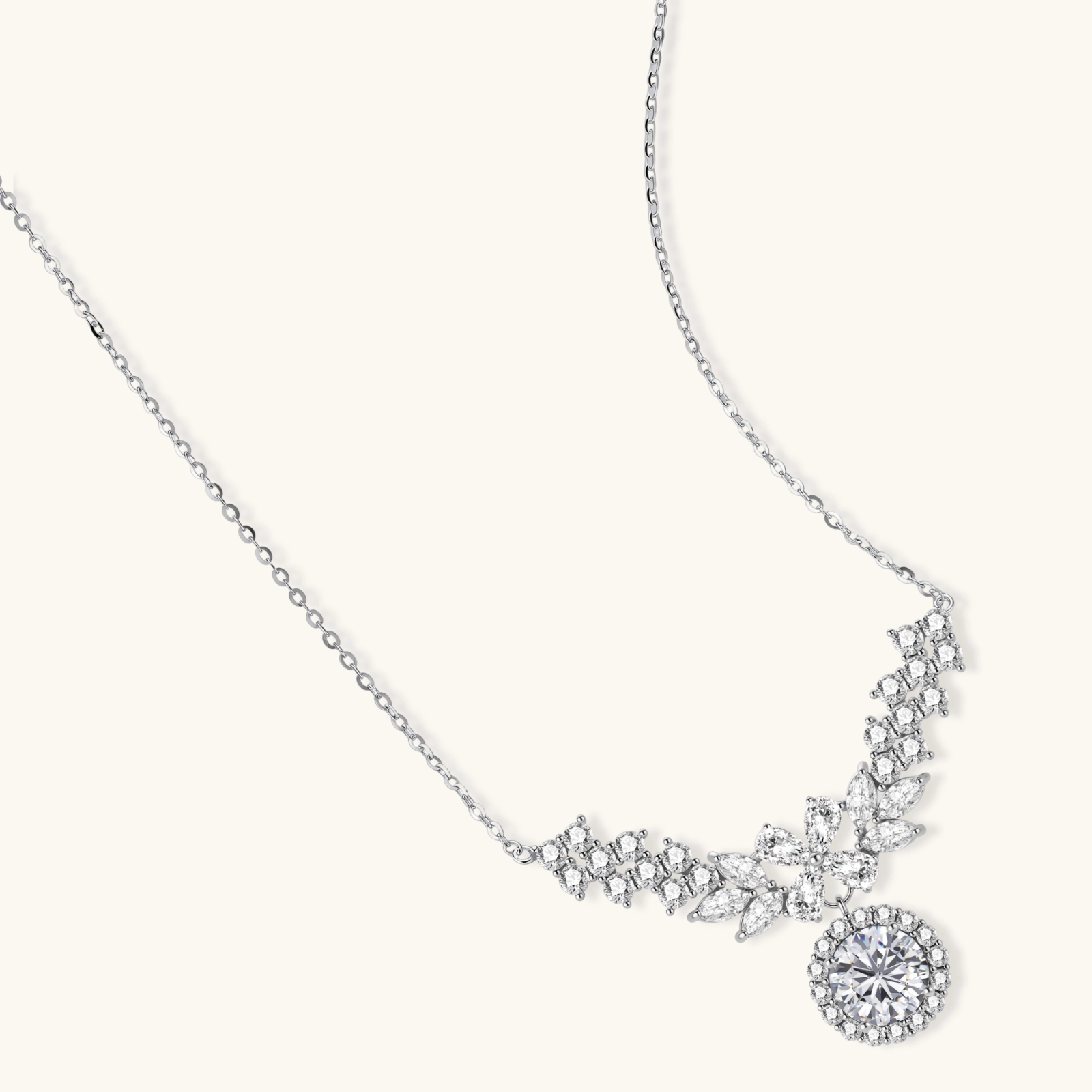 Elegant sterling silver necklace featuring intricate wing-like design with brilliant moissanite stones on neutral background.