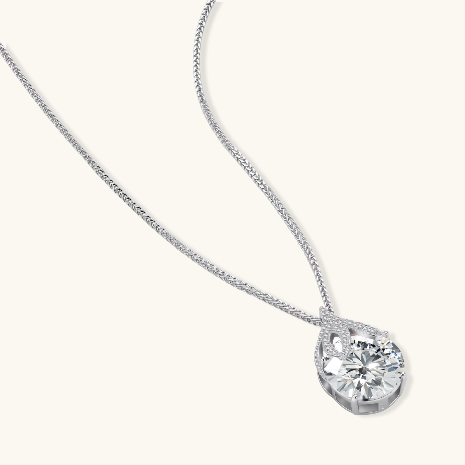 Sterling silver necklace featuring a large pear-shaped moissanite stone in an ornate setting with smaller accent stones
