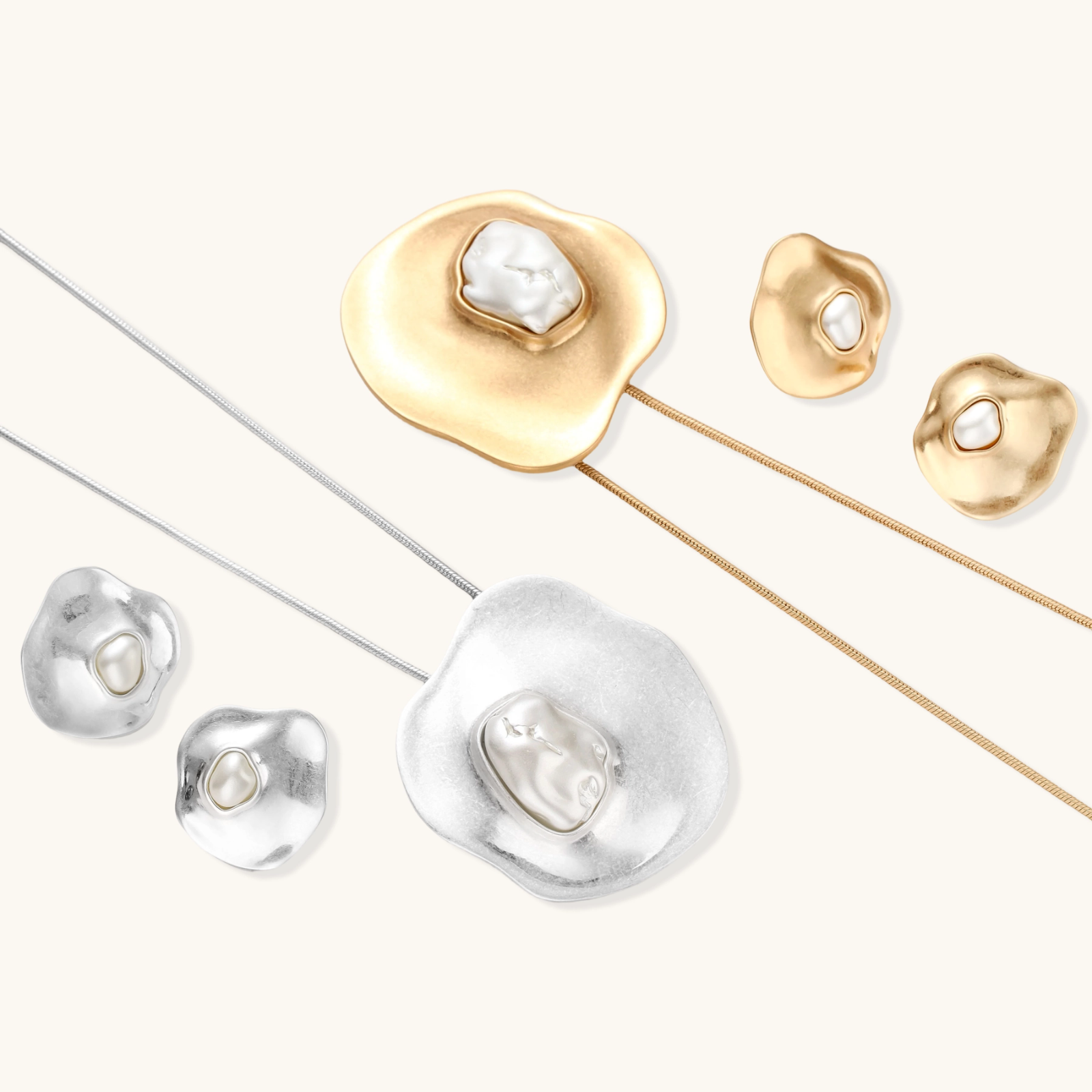 Organic-shaped gold pendant necklace with baroque pearl accent on adjustable chain, displayed against neutral background.