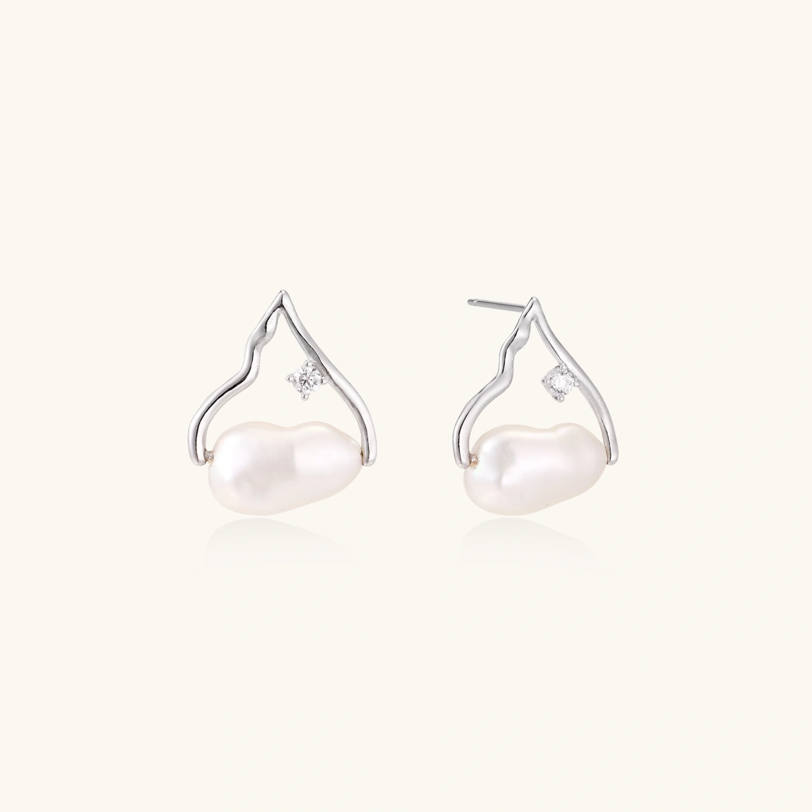 Silver mountain outline studs with baroque pearl and diamond accent on white background