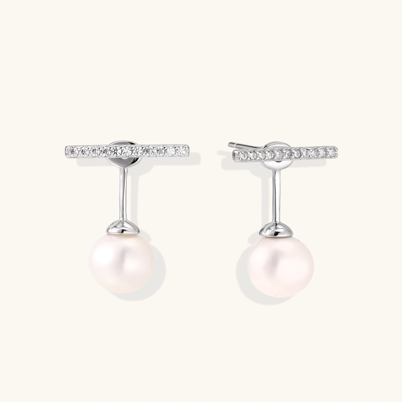 Rhodium-plated sterling silver ear jacket earrings with diamond-set horizontal bar and freshwater pearl drop