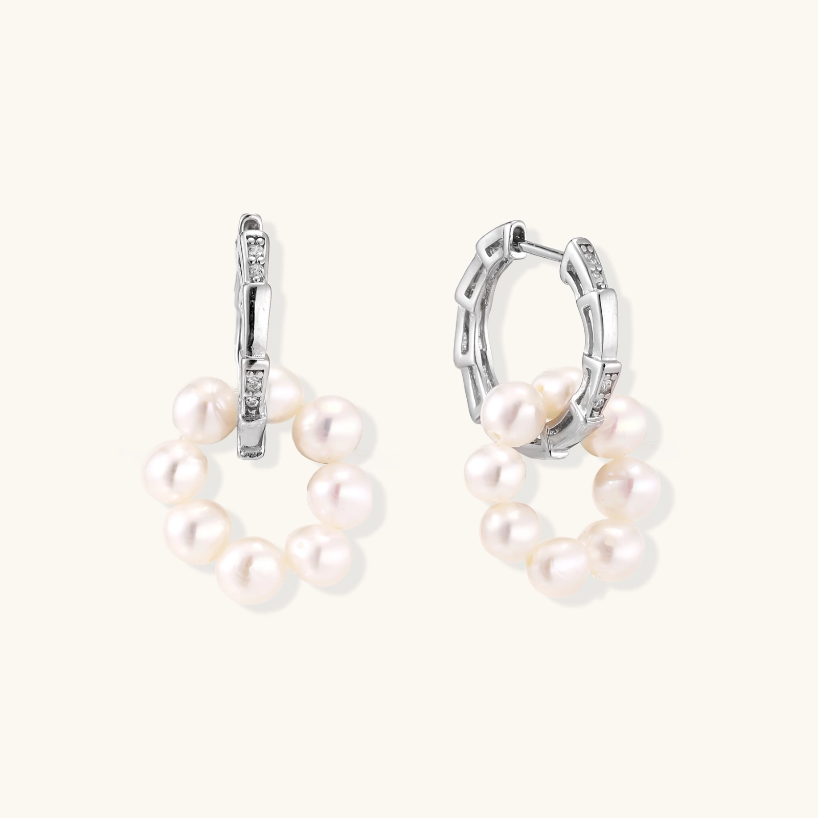 Rhodium-plated silver hoop earrings with freshwater pearls arranged in crescent formation and diamond accents