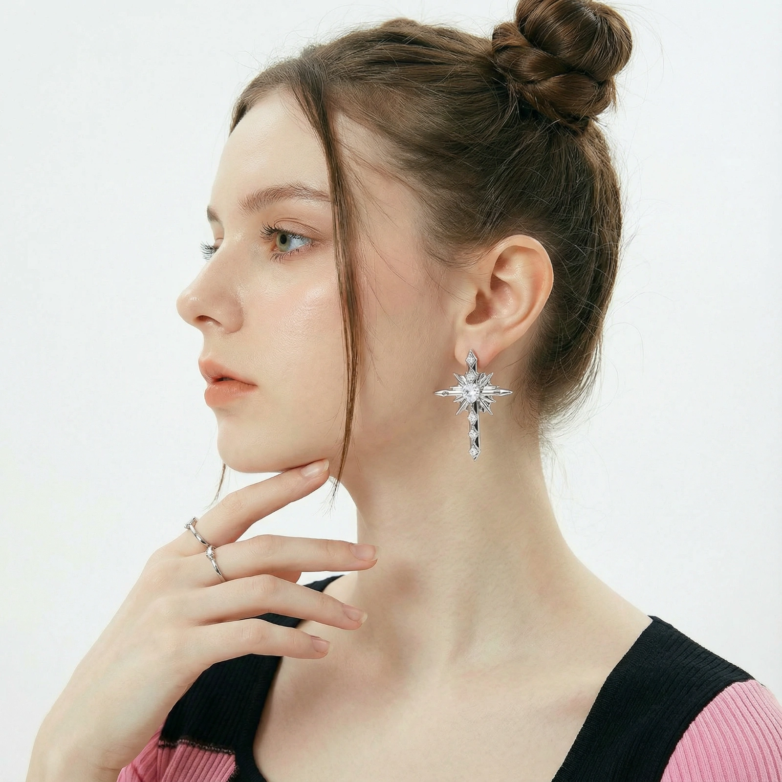 Silver starburst earrings with radiating points and dagger drop design featuring clear zirconia stones