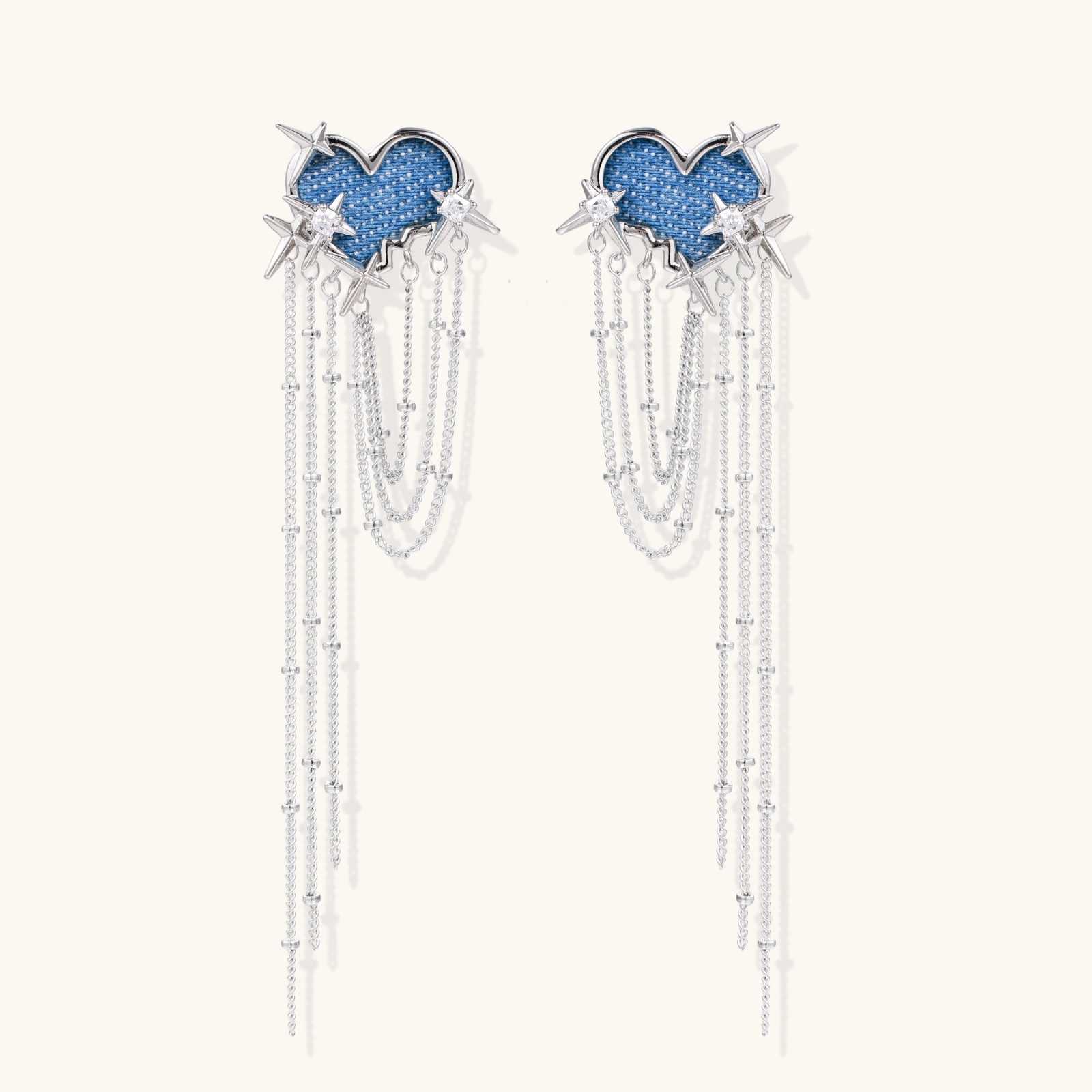 Blue denim cloud-shaped earrings with white gold plated chains, zirconia stars, and cascading silver chain details