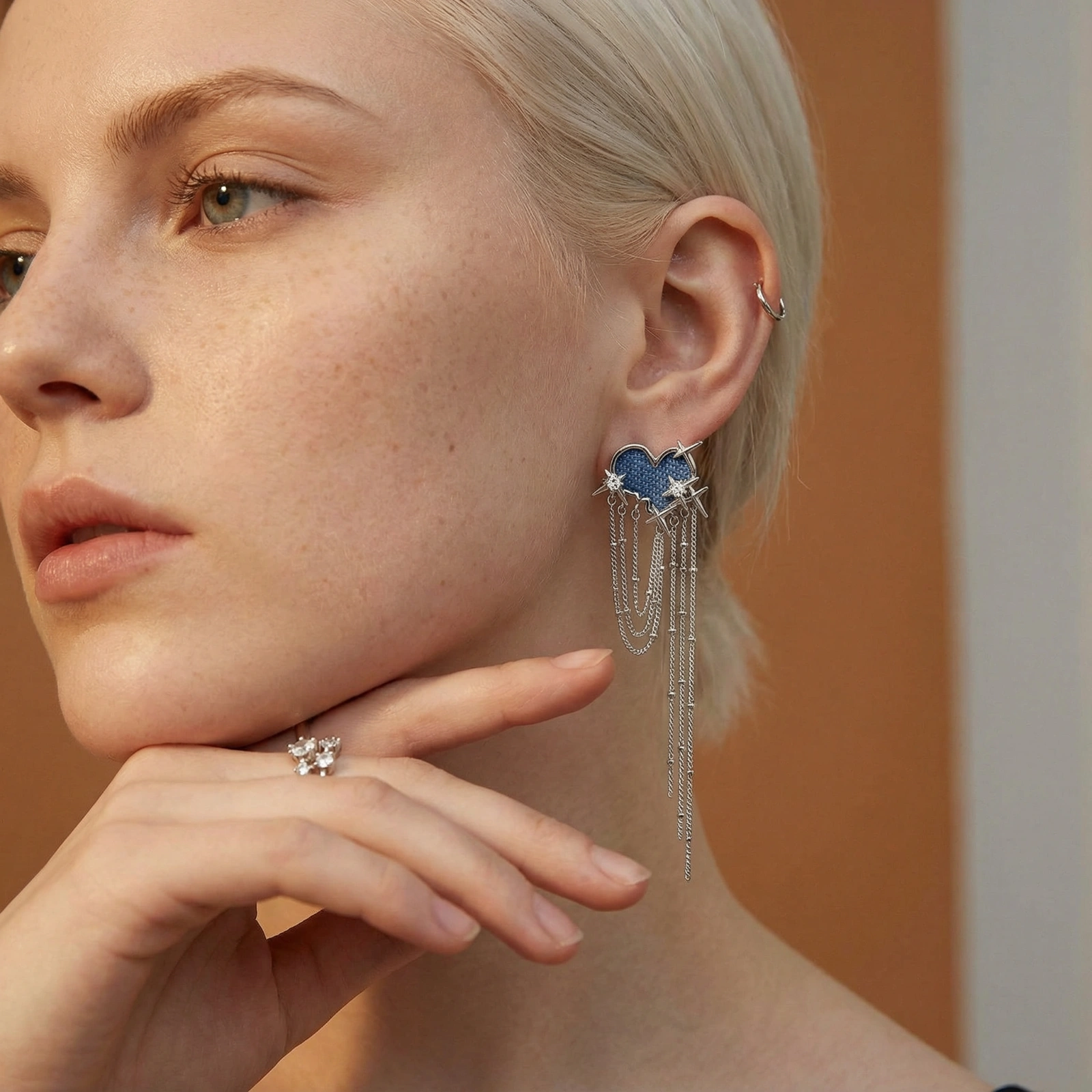 Blue denim cloud-shaped earrings with white gold plated chains, zirconia stars, and cascading silver chain details