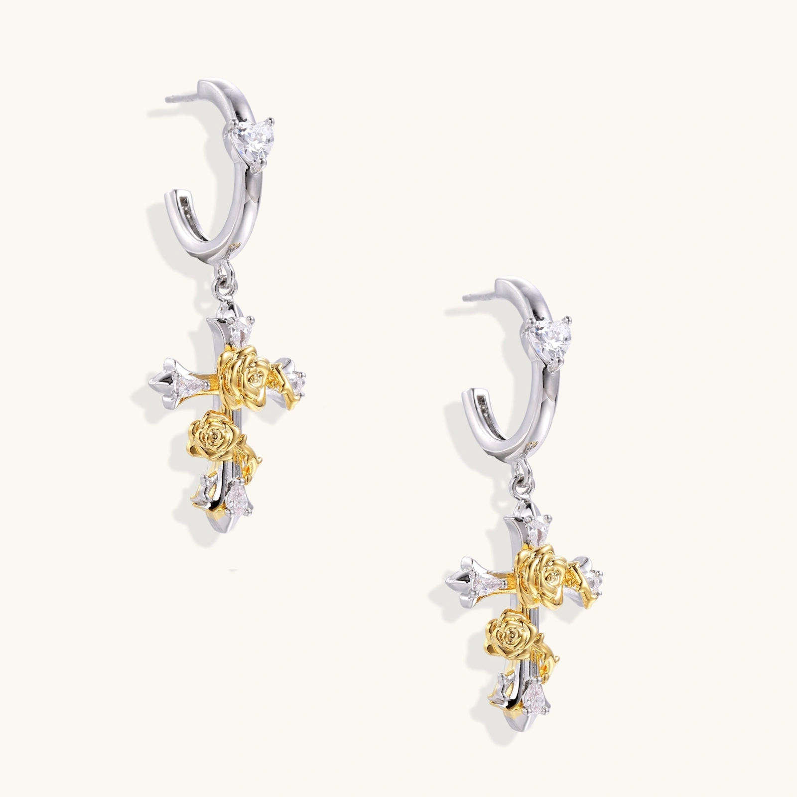 Ornate gold plated cross drop earrings with rose details and sparkling zirconia stones on white background.