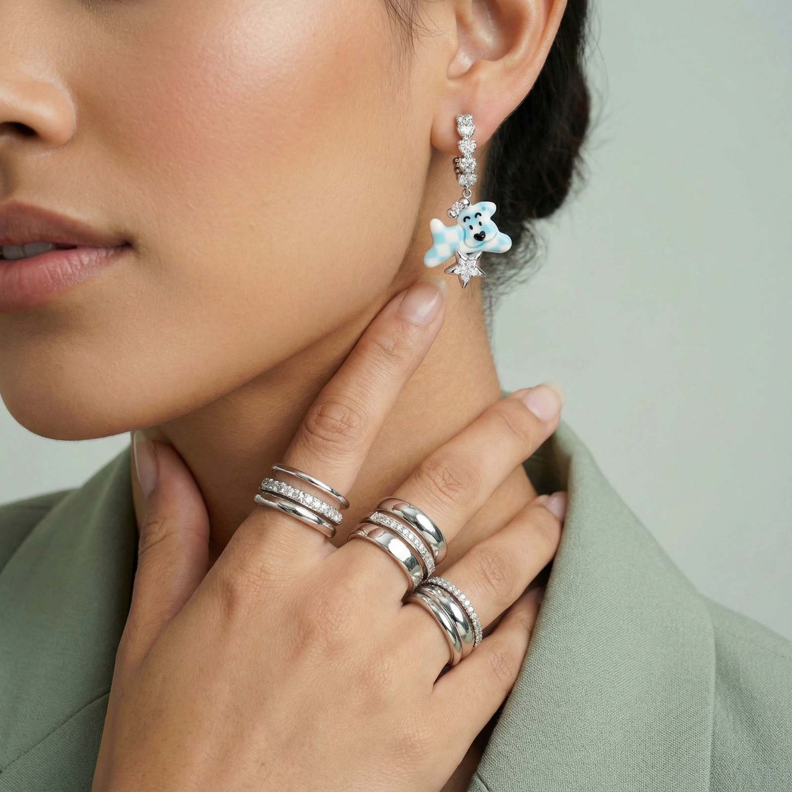 White gold plated drop earrings with crystal chain and blue checkered teddy bear charm holding star