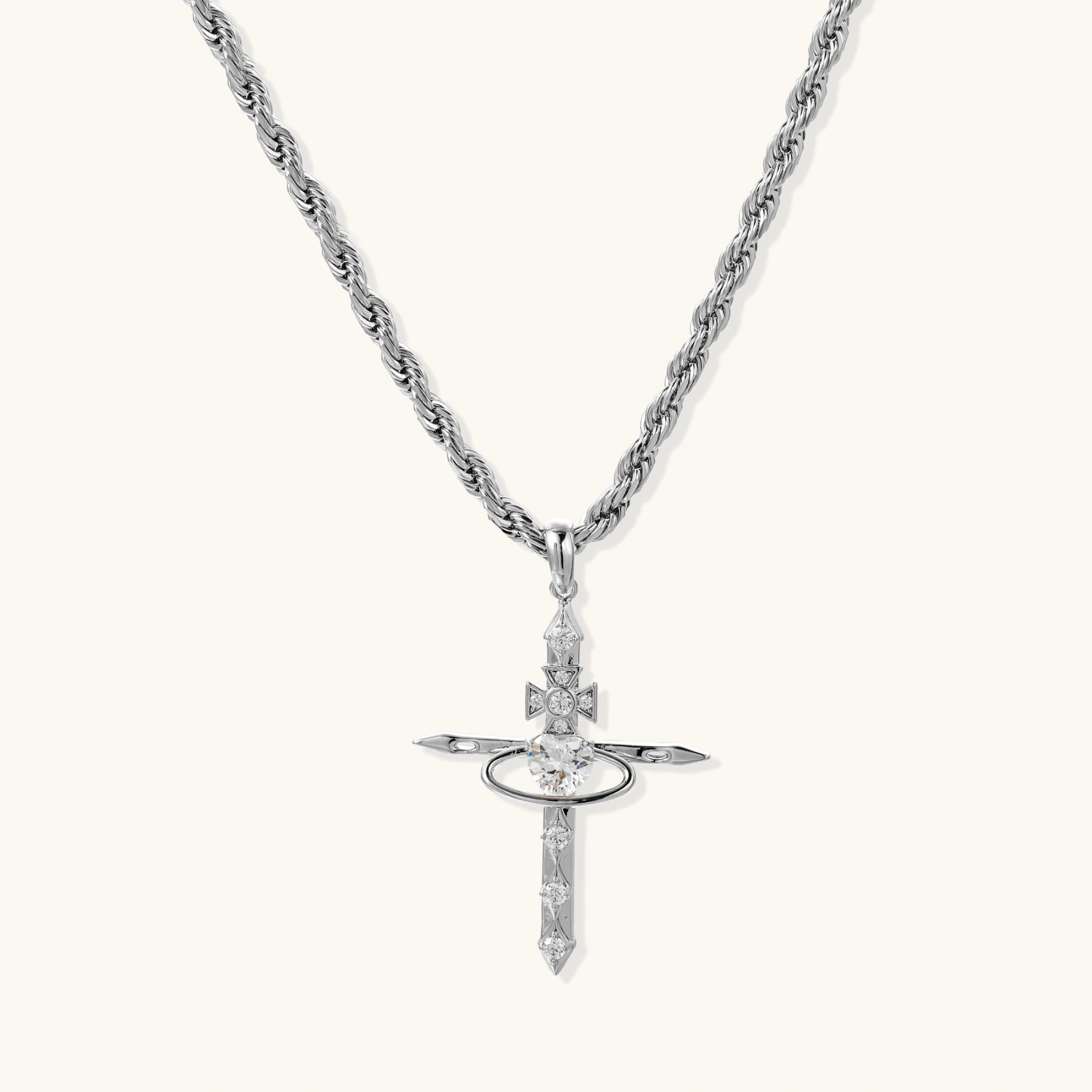 Silver-tone necklace with dimensional orb pendant, cross crown detail, and zirconia stones on twisted rope chain