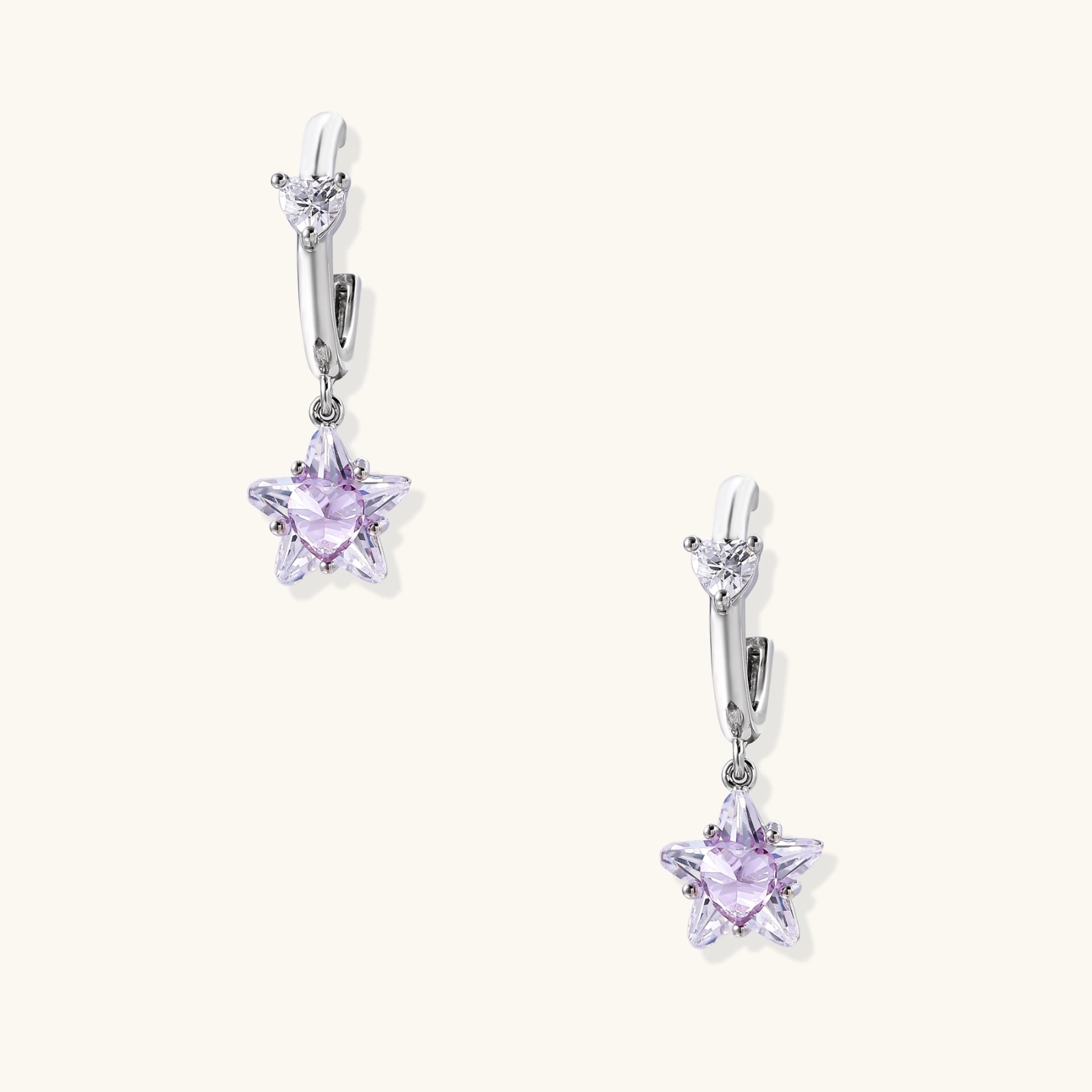 White gold plated huggie earrings with clear CZ accents and dangling lavender star-shaped crystals on cream background
