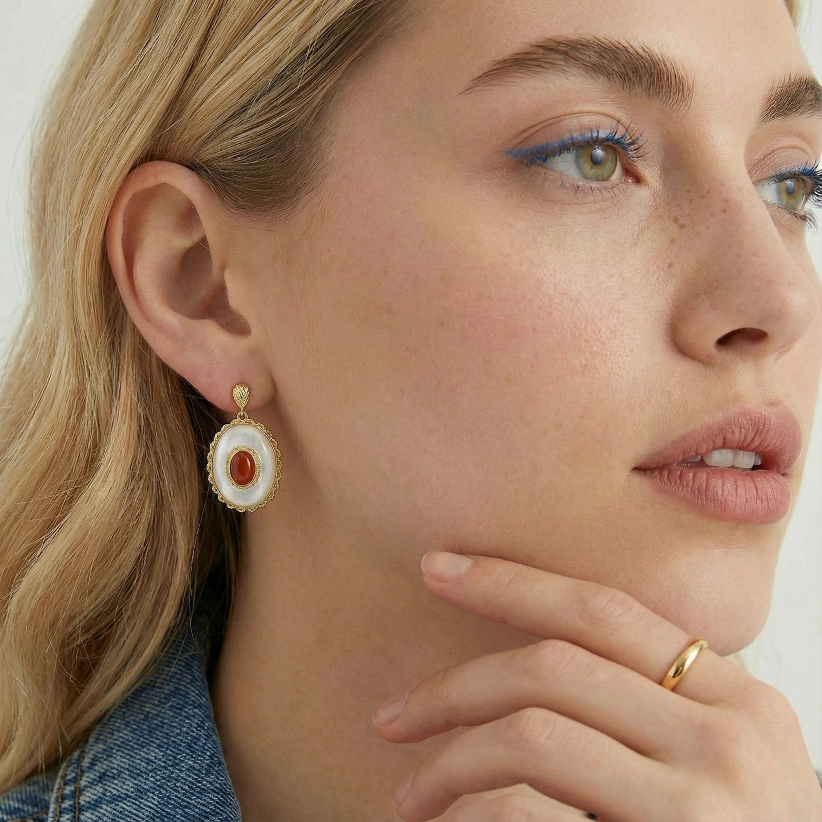 Gold-plated drop earrings with layered oval mother-of-pearl and cognac gemstone center framed by crystal halo