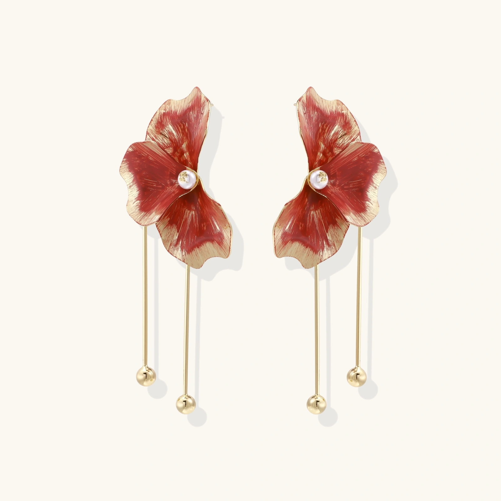 Red enamel flower earrings with gold-plated stems, central pearl, and gradient coral-to-gold petals on white background