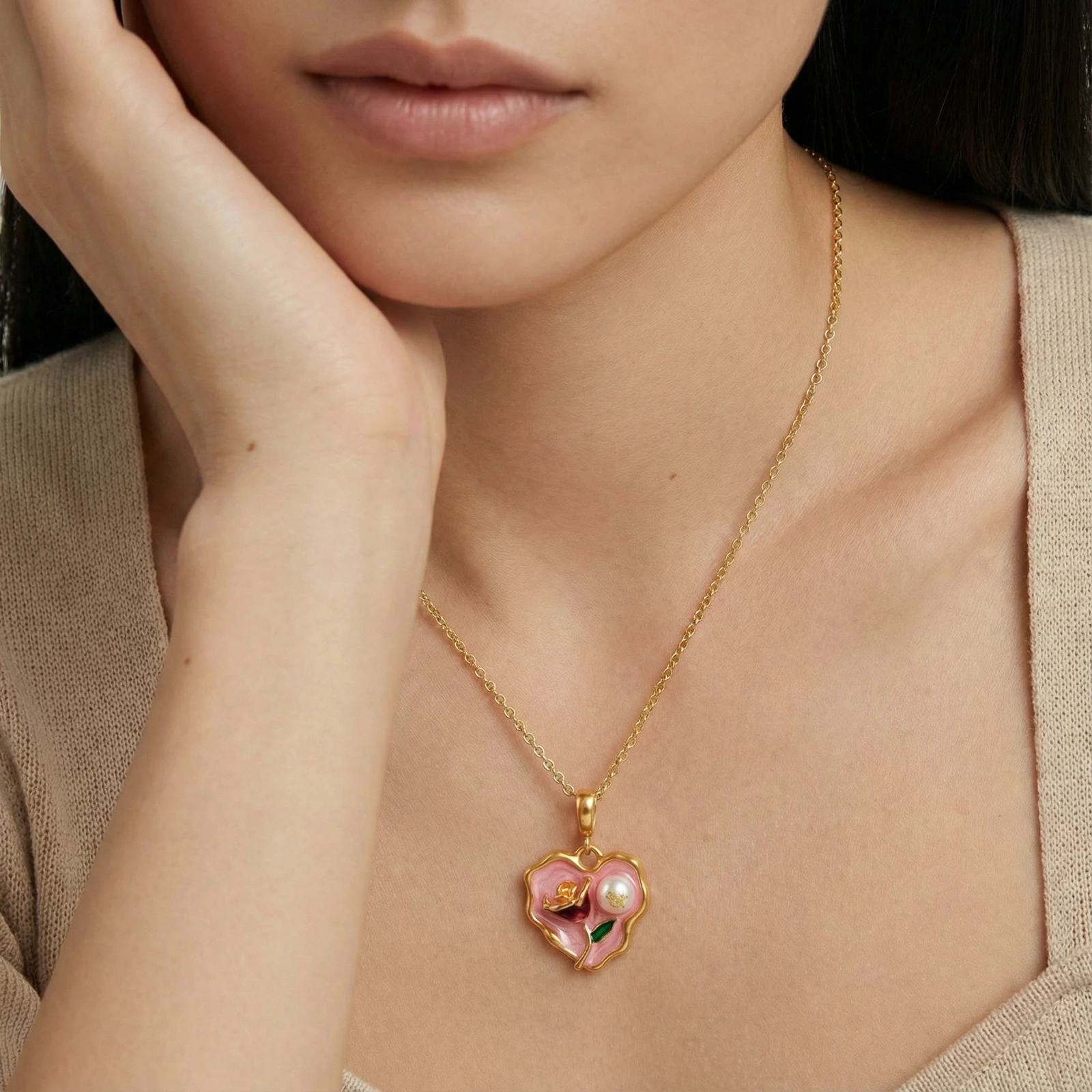 Heart-shaped pendant with pink enamel, rose design, freshwater pearl flower, and gold scalloped frame on delicate chain