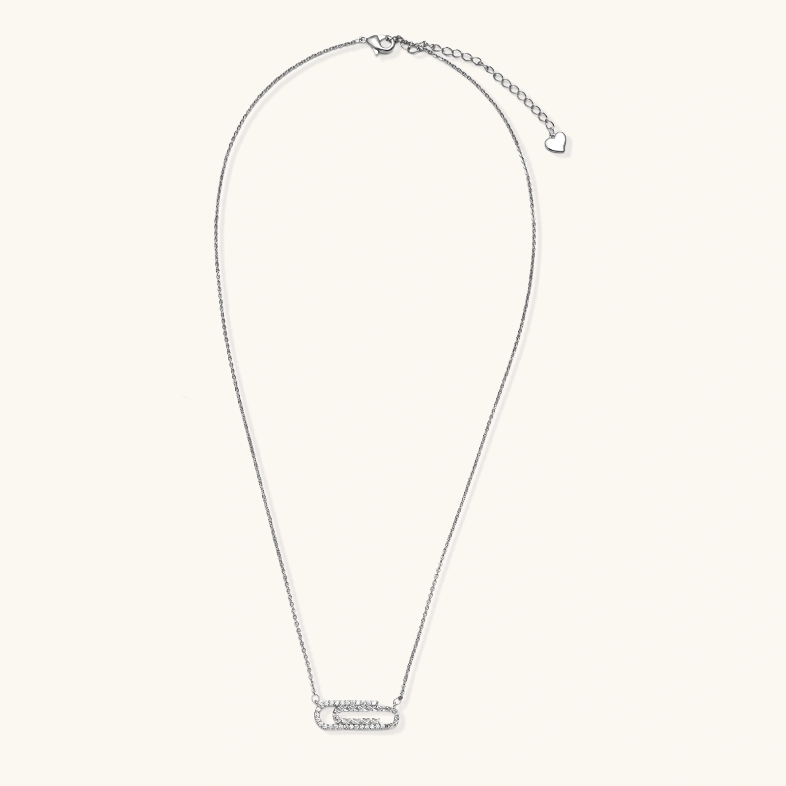 White gold plated necklace with dual-frame geometric pendant featuring crystal pavé border on pale background.