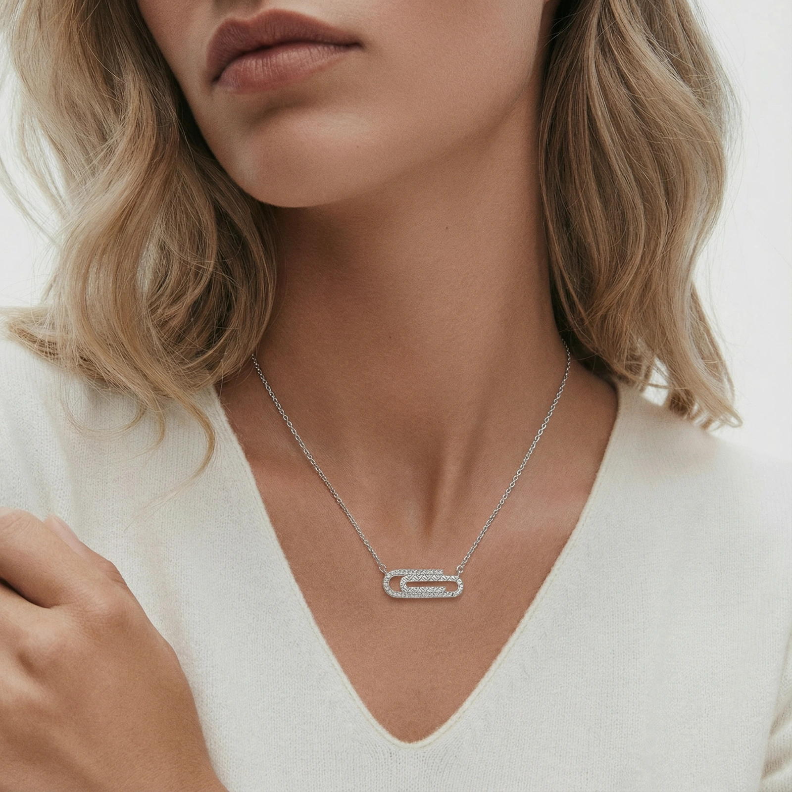 White gold plated necklace with dual-frame geometric pendant featuring crystal pavé border on pale background.