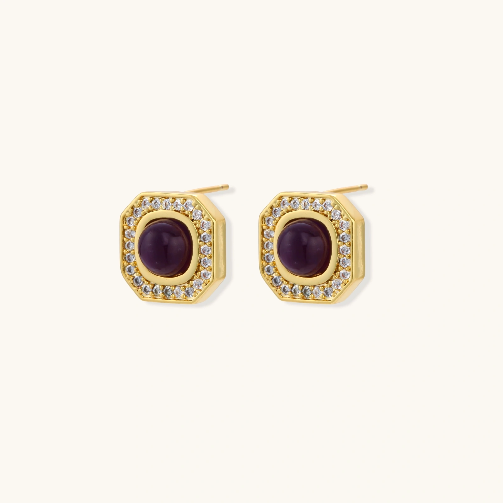 Gold-plated octagonal stud earrings with burgundy liuli centers and cubic zirconia halos on white background
