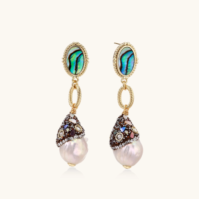 Gold drop earrings with iridescent abalone studs, rope links, jeweled caps and white baroque pearls on cream background