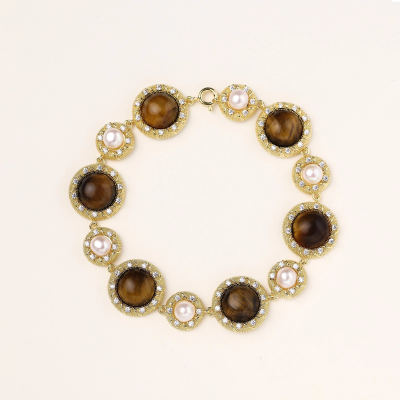 Gold-plated link bracelet with alternating brown tiger's eye stones and white freshwater pearls in ornate bezels.