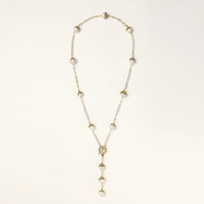 Gold-plated lariat necklace with baroque pearls and textured caps on cream background, showing adjustable Y-shaped design.