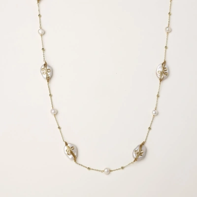 Long gold chain necklace with baroque pearls wrapped in leaf designs and small freshwater pearls spaced along the strand
