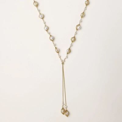 Adjustable gold lariat necklace with freshwater pearls nested in delicate cage settings and Y-shaped tassel drop