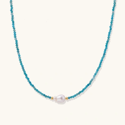 Delicate gold vermeil necklace with teal apatite beads and freshwater pearl on white background.