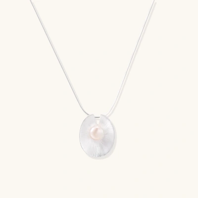 Sterling silver disc necklace with textured finish and centered freshwater pearl on delicate chain