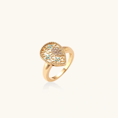 Teardrop-shaped gold-plated ring with turquoise enamel flowers and crystal pavé detail on cream background
