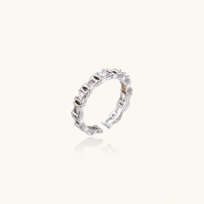 White gold plated ring with architectural lattice design and zirconia accents on cream background