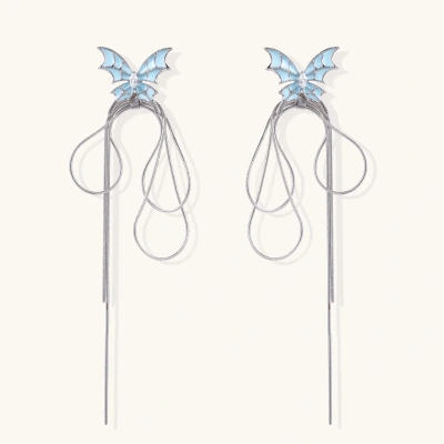 Long silver-tone earrings with powder blue enamel butterfly studs and flowing chain tassels on cream background