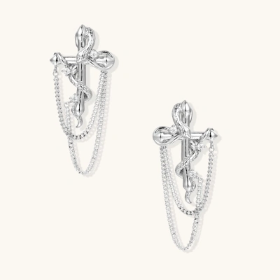Sculptural white gold bow earrings with cascading chain details on neutral background