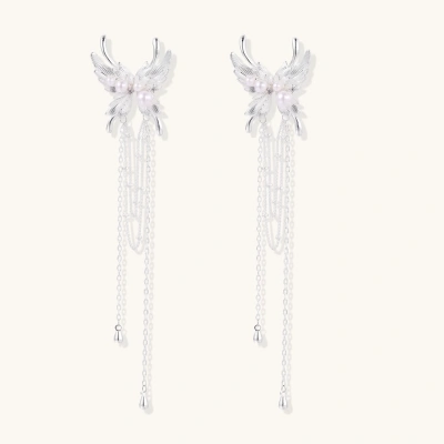 Elegant chandelier earrings with phoenix wing design, white pearls, and cascading silver chains on cream background