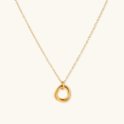 Delicate gold-plated necklace with three interlocking circle rings forming a minimalist knot pendant on cream background