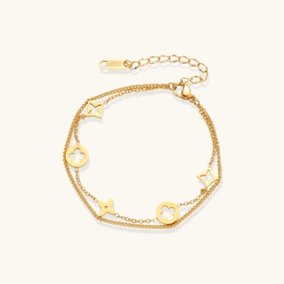 Double-layer gold-plated bracelet with quatrefoil and star charms on cream background, 18K gold finish.