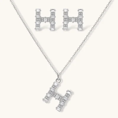 Letter H jewelry set featuring geometric crystal design in gold and white gold plated finish with adjustable chain necklace