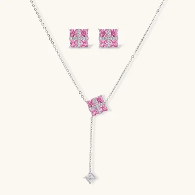 White gold plated jewelry set with pink cubic zirconia stones in geometric cross design, featuring Y-necklace and square stud earrings